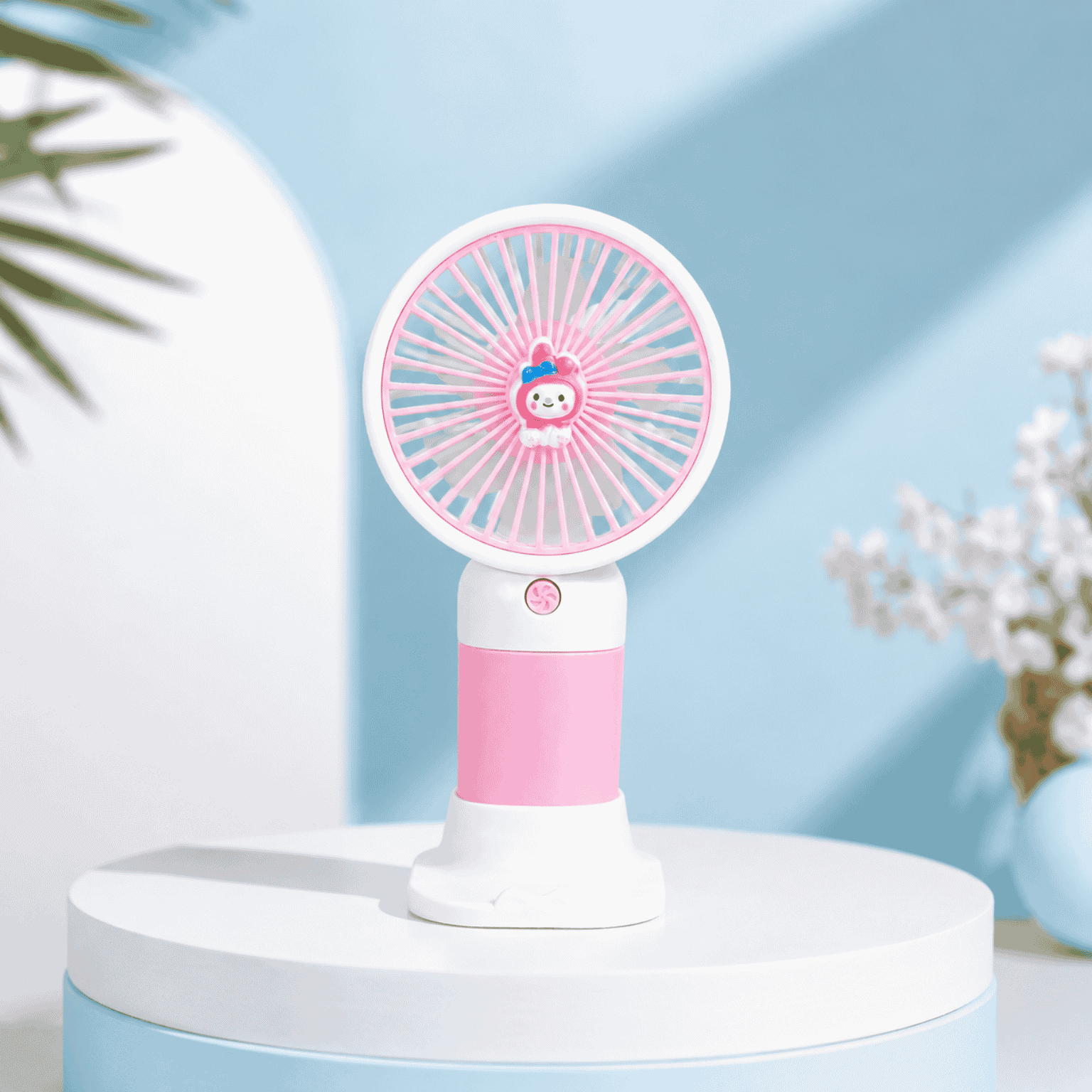 Pink and white handheld fan on a round platform with a light blue background