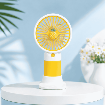 Yellow and white handheld fan on a light blue background with plants and flowers.