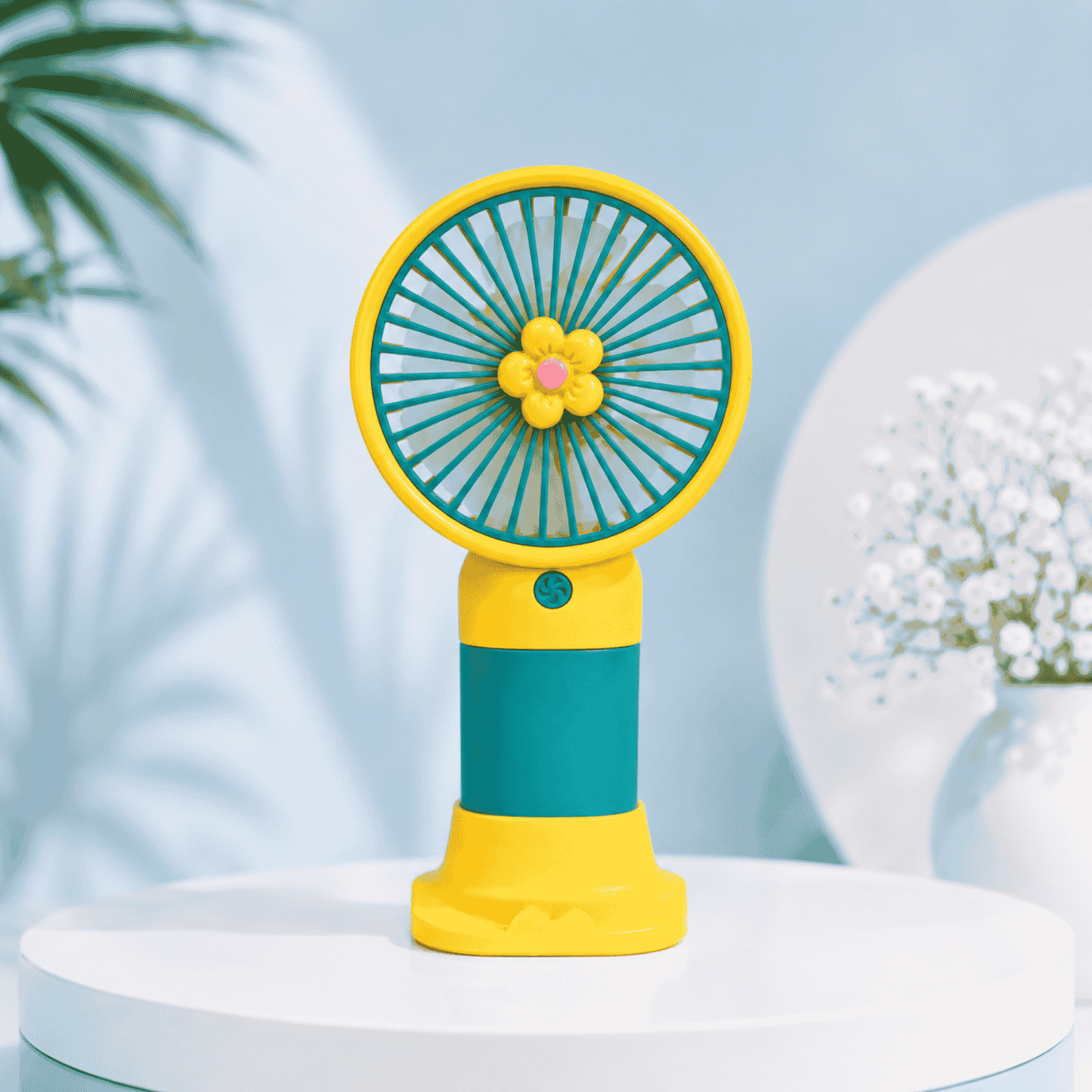 Colorful handheld fan with a floral design on a light blue background