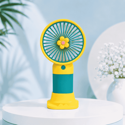 Colorful handheld fan with a floral design on a light blue background